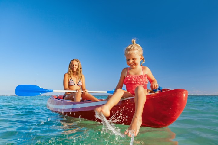 a girl riding a wave on a surfboard in the water
